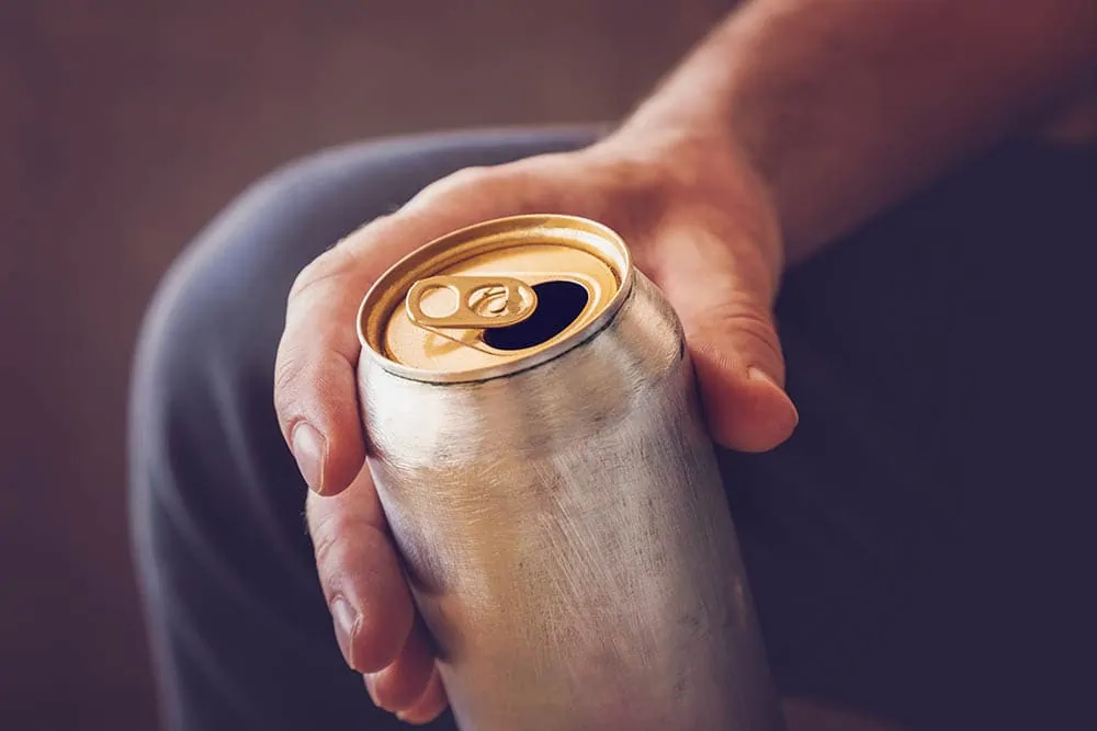 person-holding-a-can-of-energy-drink_FotoDuets_Shutterstock